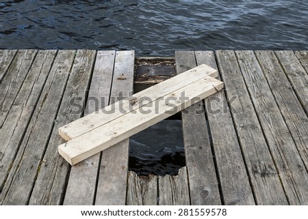 A hole in the bridge, repair of a wooden bridge.