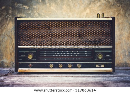 Vintage old radio receiver device in wooden dark room.
