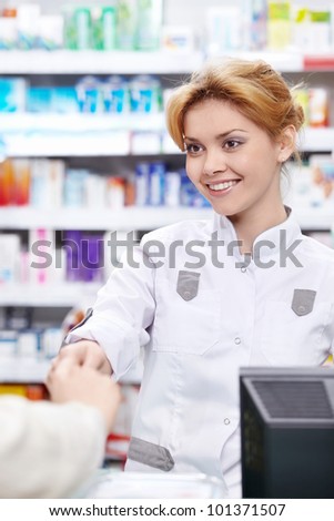 The pharmacist sells the medicine in a pharmacy