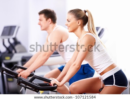 Young people on bikes in a fitness club