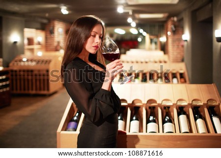 Young girl tastes the wine