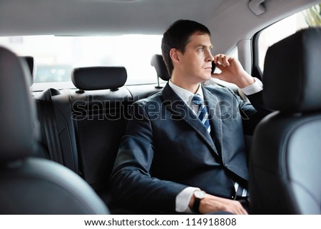 Businessman in car talking on the phone