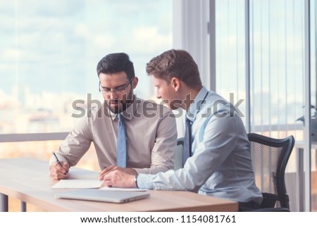 Business people signing a contract at the office