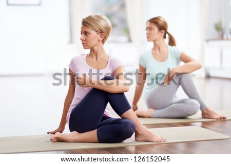 Young girls do yoga indoors