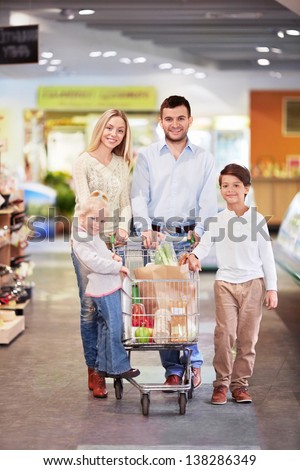 Young family with a cart in the store