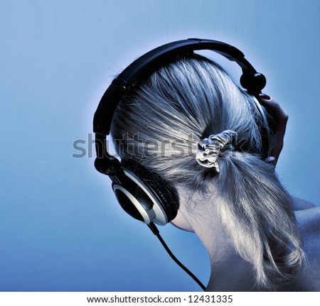 Head of the girl with light hair in headphones on a dark blue background