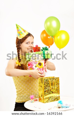 The happy young girl holds in hands set of boxes with gifts on a white background