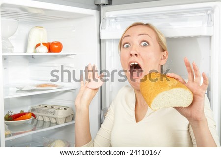 A hungry blonde surrenders at a refrigerator