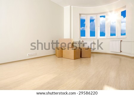 Interior of an empty room with the boxes, shined with a sunlight