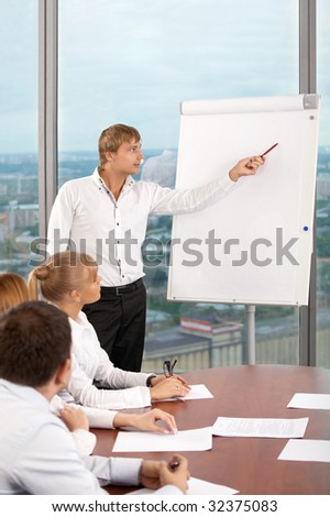 The business man shows something on a board at conference