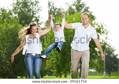 Parents with the small son frolic on the nature