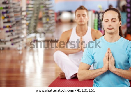 Pose of a lotus performed by two men in sport club