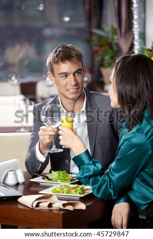 Happy young couple has dinner at restaurant