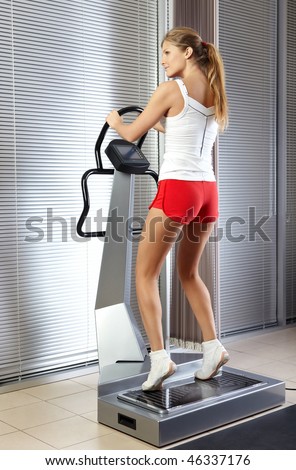 The harmonous girl is engaged on a training apparatus