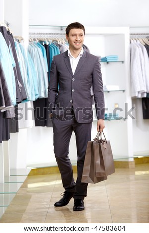 The young man with a bag in shop