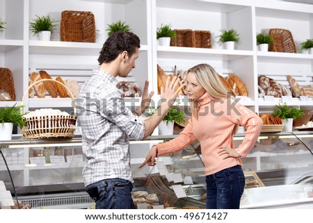 The young couple quarrels in a baker\'s shop