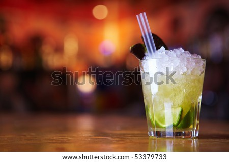 Cocktail with lime and ice in a glass