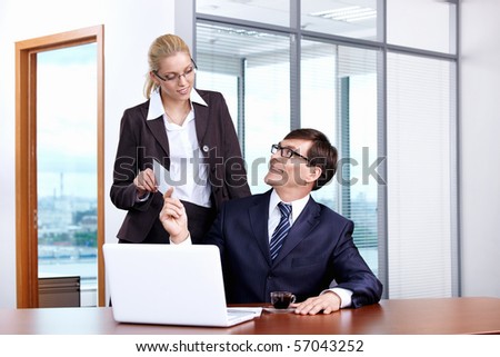 Boss gives the envelope to the secretary in the office