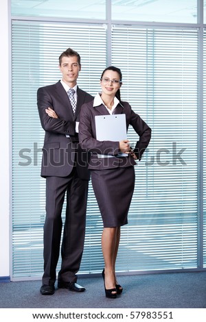 A girl and a young man in a suit at the office
