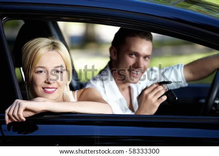 A couple in the car with the keys of her