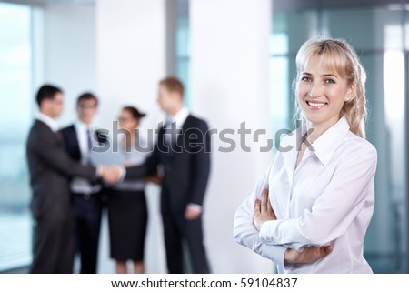 Businesswoman in office on the background of serving staff