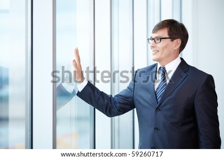 Boss looks out the window in the office