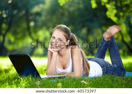 Funny girl with a laptop in the park