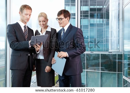 Three young men in business suits in the office