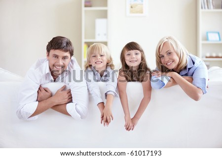 Young family on a white sofa
