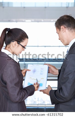 Girl shows a colleague sales chart