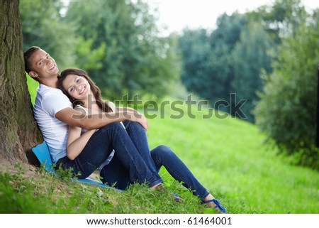Young couple in love with a tree
