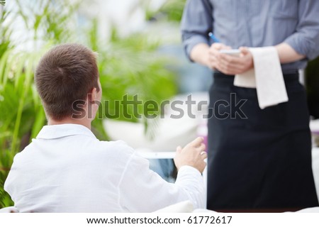 A young man makes a restaurant reservation