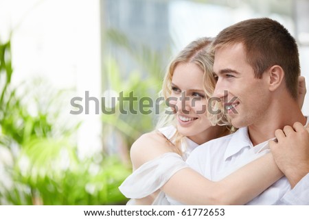 Happy young couple looking to one side