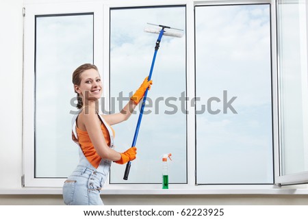 The girl washing windows mop for washing windows
