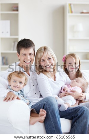 Attractive happy family with children at home