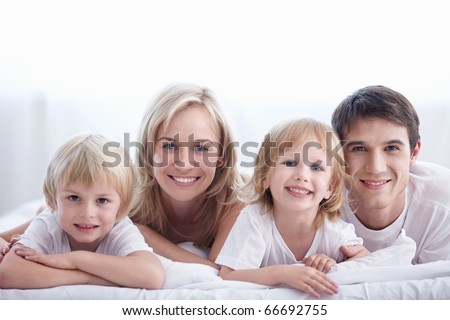 A happy family with kids in the bedroom