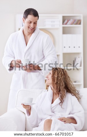 Happily married couple in dressing gowns at home