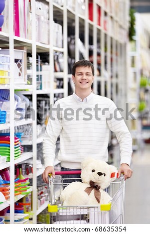 A young man with a cart in the store