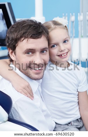 Dad with a child in the dental office