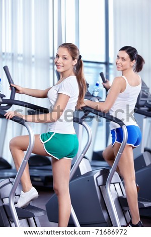 Happy young girls in the fitness club