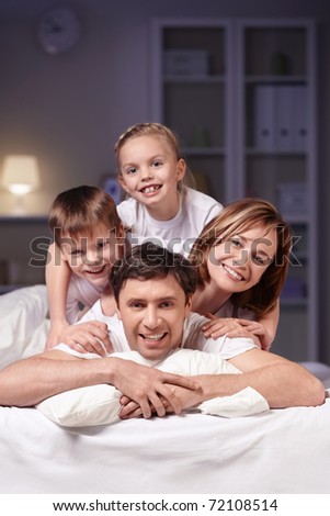 Families in bed at night at home