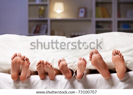 Feet sticking out from under the blanket Feet sticking out from under the blanket