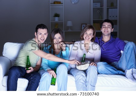 Young people watch TV at home