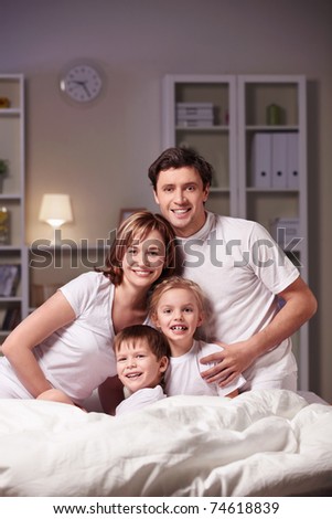Parents with children in the bedroom at night