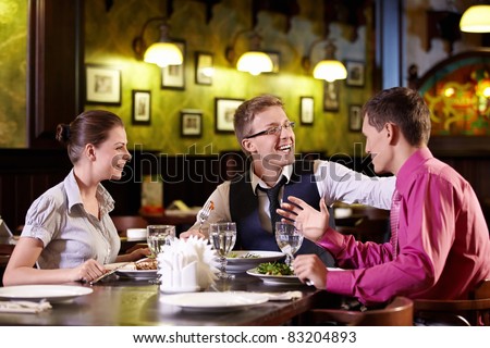 Young people having dinner at a restaurant