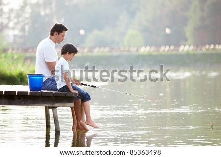 Man and boy fishing on the lake