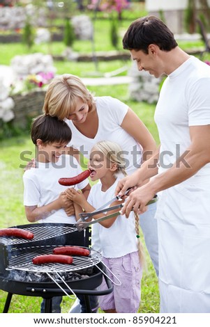 Family with children does barbecue