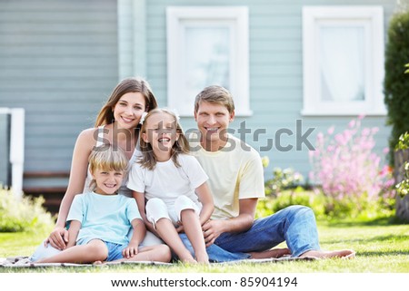 Laughing family with children outdoors