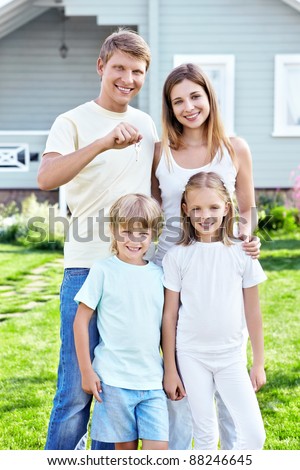 Family with the keys in the background house