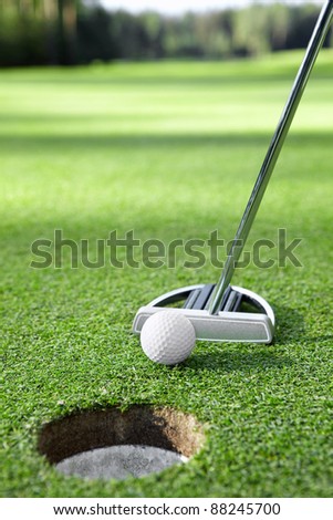 Stick pushes the ball in the hole